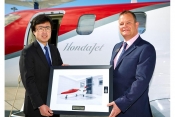 Howard Povey accepts the keys to HondaJet M-HNDA from Michimasa Fujino, President and CEO of Honda A